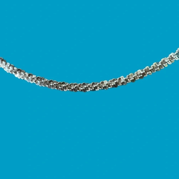 925 Sterling Silver Diamond Cut Margarita Chain Necklace  Sterling Silver Necklace made in Italy.  Very light gold tone signed and sparkle